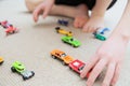 Boy playing with car collection on carpet