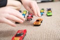 Boy playing with car collection on carpet.Child hand play. Transportation, airplane, plane and helicopter toys for children