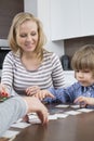 Boy playing cards with parents at home Royalty Free Stock Photo