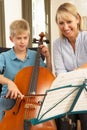 Boy playing cello in music lesson