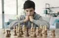 Boy playing chess at home Royalty Free Stock Photo