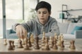 Boy playing chess at home Royalty Free Stock Photo