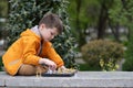 Boy playing chess outdoor. Learning strategic game. Education Royalty Free Stock Photo
