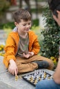 Boy playing chess outdoor. Learning strategic game. Education Royalty Free Stock Photo