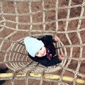 Boy playing on climbing frame