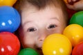 Boy playing in colorful balls playground