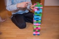 Boy playing colorful Jenga game