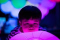 A boy is playing colorful light balls.