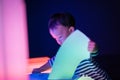 A boy is playing colorful light cubes