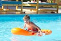 Boy playing on dingy in pool Royalty Free Stock Photo
