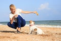 The boy is playing with Dog on the beach Royalty Free Stock Photo