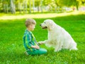 Boy playing with the dog on green grass Royalty Free Stock Photo