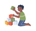 Boy playing educational wooden cubes with abc