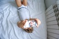 Boy playing on electronic gadget tablet in his bedroom. Social problem of communication of children in the modern world.