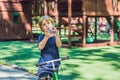 Boy playing with fidget spinner. Child spinning spinner on the playground. Blurred background