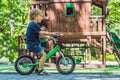 Boy playing with fidget spinner. Child spinning spinner on the playground. Blurred background