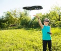 Boy playing with flying drone with camera controlled by smartphone Royalty Free Stock Photo