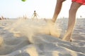 Boy playing football on the beach