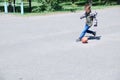 Boy playing football, child run with ball on asphalt, soccer team player, training outdoor, active lifestyle Royalty Free Stock Photo