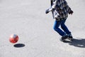 Boy playing football, child run with ball on asphalt, soccer team player, training outdoor, active lifestyle Royalty Free Stock Photo