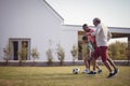 Boy playing football with his father and grandson Royalty Free Stock Photo
