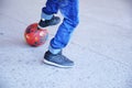 Boy playing football, teenager`s legs with a ball on asphalt, soccer team player, training outdoor, active lifestyle Royalty Free Stock Photo