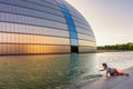 Boy playing in front of the National Centre of Performing Arts in Beijing, China Royalty Free Stock Photo