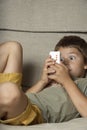 Boy Playing Game on Cell Phone Royalty Free Stock Photo