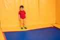 A boy is playing in a game entertainment nursery. The child is upset, crying. Active pastime in the amusement park