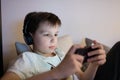 Boy playing game on smartphone Royalty Free Stock Photo