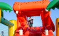 Boy Playing on Giant Red Inflatable Hippopotamus Royalty Free Stock Photo
