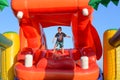 Boy Playing on Giant Red Inflatable Hippopotamus Royalty Free Stock Photo