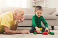 Boy playing with grandfather in building kit Royalty Free Stock Photo