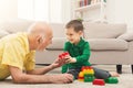 Boy playing with grandfather in building kit Royalty Free Stock Photo