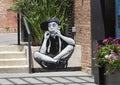 Boy playing a harmonica by multidisiplinary artist Joe Iurato in Deep Ellum in East Dallas, Texas.