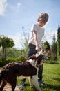 Boy is playing with his dog outside