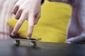Boy is playing with his finger skateboard. Close up shot. Royalty Free Stock Photo