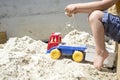 Boy Playing with his Truck Toy at the Beach Sand Royalty Free Stock Photo