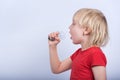 Boy playing with incandescent lamp. Child sings into lightbulb like into microphone Royalty Free Stock Photo