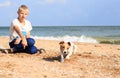 The boy is playing with Dog on the beach Royalty Free Stock Photo