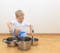 Boy playing with kitchen utensils Royalty Free Stock Photo