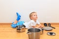 Boy playing with kitchen utensils Royalty Free Stock Photo