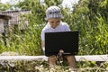 Boy playing laptop on the nature Royalty Free Stock Photo