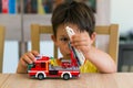 Boy playing with Lego fire truck Royalty Free Stock Photo