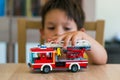 Boy playing with Lego fire truck Royalty Free Stock Photo