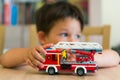 Boy playing with Lego fire truck Royalty Free Stock Photo