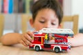 Boy playing with Lego fire truck Royalty Free Stock Photo