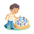 Boy Playing with Marble Maze Puzzle Toy, Enhancing Problem-Solving Skills and Cognitive Development Royalty Free Stock Photo