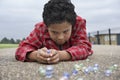 Boy Playing Marbles On Playground Royalty Free Stock Photo