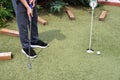 Boy playing in minigolf